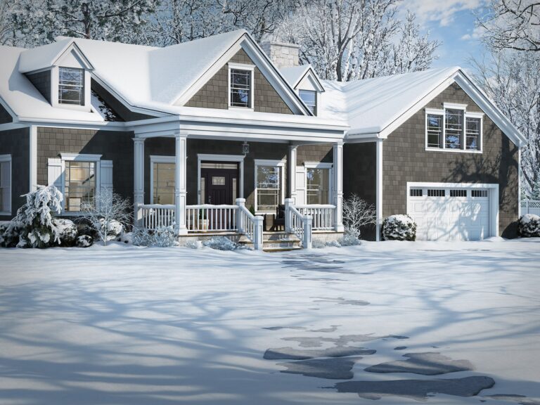 Snow covered house with elegant custom entry door and windows