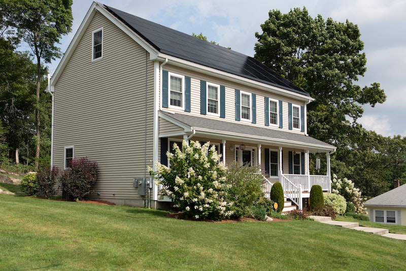 two story home with solar panels