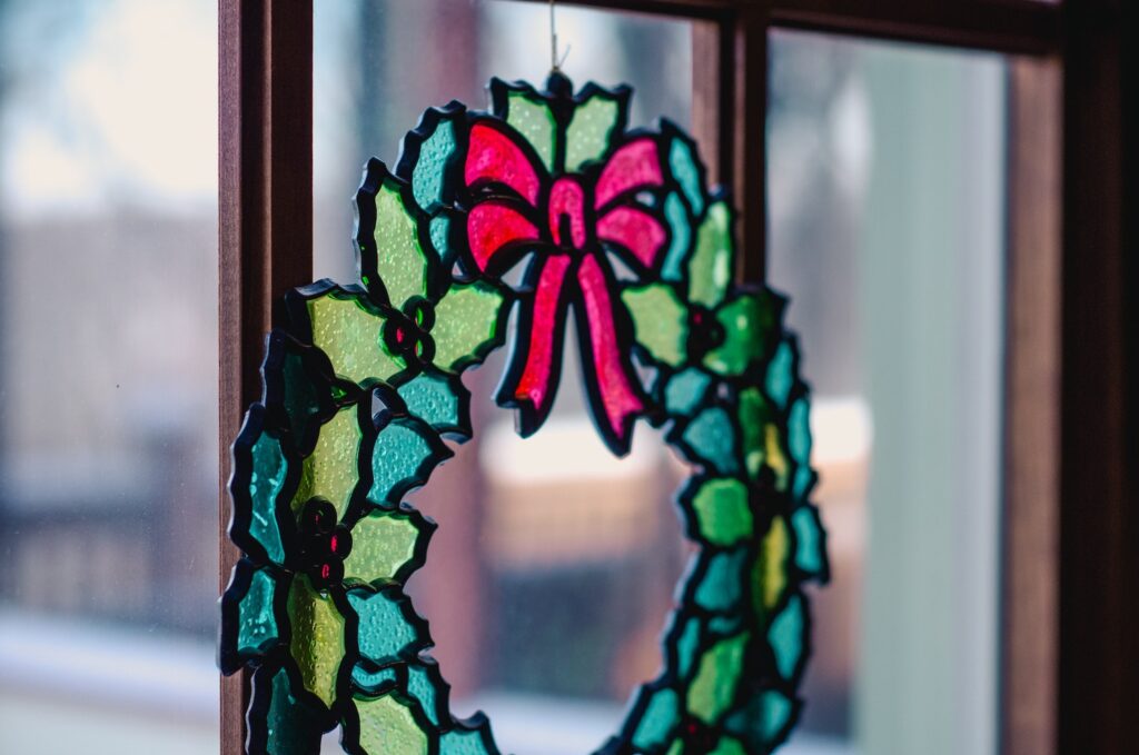 winter holiday stained glass wreath in window
